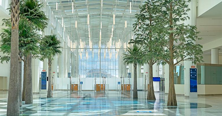 Orlando International Airport Terminal C - 1.8 million square feet terminal with 1,000-foot skylit Boulevard featuring palm trees and natural light